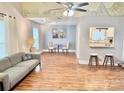 Bright living room with hardwood floors, modern decor, and a unique mural overhead, perfect for entertaining at 7133 Tall Tree Ln, Charlotte, NC 28214
