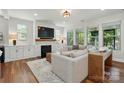 Spacious living room features a fireplace, large windows for natural light, and hardwood floors at 7322 Vesper Dr, Huntersville, NC 28078