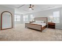 Serene main bedroom with tray ceiling, plush carpet, and ample natural light at 7322 Vesper Dr, Huntersville, NC 28078