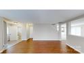 Open living space with hardwood floors, neutral walls, and a view of the stairway leading upstairs at 8139 Deodora Cedar Ln, Charlotte, NC 28215
