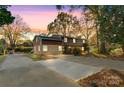 Beautiful shot of a home's exterior featuring a large driveway, brick accents, and an attached section at 841 12Th Nw Ave, Hickory, NC 28601