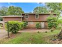 Charming two-story home with wood panel exterior, lush landscaping, and a welcoming entrance at 841 12Th Nw Ave, Hickory, NC 28601