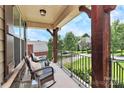 Inviting front porch offers comfortable seating and neighborhood views, perfect for relaxing at 9011 Kensington Forest Dr, Harrisburg, NC 28075