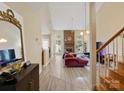 Open-concept living room featuring a brick fireplace and wood-look flooring at 9121 Kings Canyon Dr, Charlotte, NC 28210