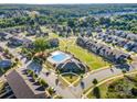 Community aerial view showcasing a pool and neighborhood with well-maintained landscaping and manicured lawns at 915 Claires Creek Ln, Davidson, NC 28036