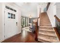 Bright foyer with hardwood floors and staircase leading to the upper level at 915 Claires Creek Ln, Davidson, NC 28036