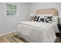 Bedroom with a stylish headboard, decorative pillows, and a neutral color scheme, creating a relaxing atmosphere at 918 Creekridge Dr, Monroe, NC 28110