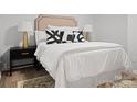 Beautifully decorated bedroom featuring a stylish headboard, black and white pillows and a modern nightstand at 918 Creekridge Dr, Monroe, NC 28110