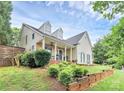 Well-maintained home with stone accents, dormer windows, and a professionally landscaped yard for enhanced curb appeal at 10449 Quiet Bay Ct, Charlotte, NC 28278