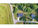 Aerial view of home nestled among lush trees, showcasing its location, driveway, and surrounding landscape at 105 Saddlewood Ln, Statesville, NC 28625