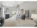 Bright living room with high ceilings, a fireplace, and access to the outdoors at 1061 Woodglen Ln, Matthews, NC 28104
