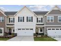 Charming two-story townhome with white siding, black shutters, and a two-car garage at 1213 Margo Mannor Dr, Fort Mill, SC 29708