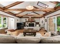 Inviting living room featuring exposed beam ceilings, wood floors, brick fireplace, and modern decor at 1226 Tarrington Ave, Charlotte, NC 28205