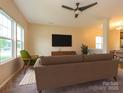 Inviting living room, staged with modern furniture, plush rug, and neutral decor, perfect for relaxation at 13022 Hill Pine Rd, Midland, NC 28107