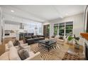 Open-concept living room featuring hardwood floors, a fireplace, and an open view to the kitchen and backyard at 1315 Charles Ave, Charlotte, NC 28205