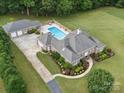 Aerial view showcasing a luxurious home with a pool, spacious garage, and beautifully landscaped backyard at 1340 Canter Ln, York, SC 29745