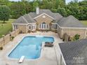 Relaxing backyard pool area featuring a diving board, lounge chairs, and a privacy fence at 1340 Canter Ln, York, SC 29745