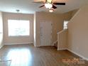Bright living room featuring hardwood floors, a ceiling fan and lots of natural light at 13441 Calloway Glen Dr, Charlotte, NC 28273