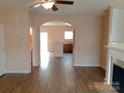 Open-concept living space with hardwood floors, fireplace, and kitchen access at 13441 Calloway Glen Dr, Charlotte, NC 28273