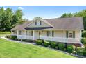 Attractive single-Gathering home with a cozy front porch, manicured shrubs, and lush green lawn at 136 Barringer Dr, Statesville, NC 28625