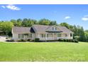 Charming single-story home featuring a welcoming front porch and beautifully landscaped front yard at 136 Barringer Dr, Statesville, NC 28625