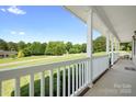 Relaxing front porch view showcasing lush greenery and serene surroundings at 136 Barringer Dr, Statesville, NC 28625