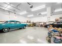 Expansive garage featuring vehicles, storage, overhead lighting, and a clean, well-maintained floor at 136 Barringer Dr, Statesville, NC 28625