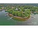 Breathtaking aerial view highlighting the property's shoreline and tranquil lake setting at 145 Hunters Pointe Ln, Mooresville, NC 28117
