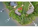 Aerial view of the beautiful lakefront property showcasing its mature trees and long shoreline at 145 Hunters Pointe Ln, Mooresville, NC 28117