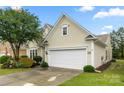 This home features an attached two-car garage and a well-manicured front yard with mature landscaping at 15152 Legend Oaks Ct, Indian Land, SC 29707
