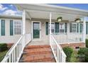 Inviting front porch with brick steps and a white railing with flower baskets at 1744 Marsley Ln, Rock Hill, SC 29730