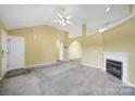 Bright living room featuring neutral carpet, ceiling fan, and fireplace at 1744 Marsley Ln, Rock Hill, SC 29730
