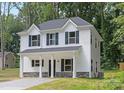 Side view of a two-story white home showing the architectural style and landscaping at 1815 Wildwood Dr, Charlotte, NC 28214