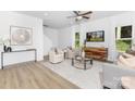 Bright living room featuring modern furniture, neutral tones, a ceiling fan, and natural light from windows at 1815 Wildwood Dr, Charlotte, NC 28214