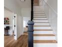 Elegant staircase with hardwood steps and white painted risers and banisters at 1833 The Plz, Charlotte, NC 28205