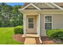 Inviting front entrance with decorative door, trimmed shrubbery and manicured lawn at 1907 Sandal Brook Rd, Fort Mill, SC 29707