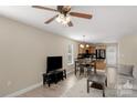 Open living room with modern decor flows seamlessly into the dining and kitchen areas at 1907 Sandal Brook Rd, Fort Mill, SC 29707