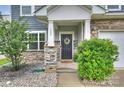 Inviting front porch with stone pillars, a decorative wreath on the door, and manicured bushes at 198 Wrangell Dr, Mooresville, NC 28117