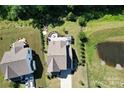 Expansive backyard featuring a patio area with a fire pit, pergola, and lush landscaping at 2035 Beacon Ave, Monroe, NC 28110