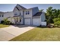 Beautiful two-story home with an attached two-car garage, well-maintained lawn, and front porch at 2035 Beacon Ave, Monroe, NC 28110