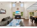 Bright living room with a vaulted ceiling, fireplace, and comfortable seating at 225 Tasman Dr, Mount Holly, NC 28120