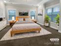 Serene main bedroom with natural light, neutral tones, tray ceiling, and stylish decor at 263 Lauren Pines Dr, York, SC 29745
