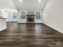 Bright living room boasts hardwood floors, large windows, and a cozy stone fireplace at 263 Lauren Pines Dr, York, SC 29745