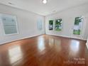 Bright and airy living room with hardwood floors, multiple windows providing lots of natural light, and a glass exterior door at 27415 Cinderella Cir, Lancaster, SC 29720