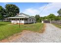 Home with a gravel driveway leading to a detached carport and fenced yard at 3345 Long Ferry Rd, Salisbury, NC 28146