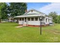 Inviting home featuring a well-maintained lawn and a cozy front porch at 3345 Long Ferry Rd, Salisbury, NC 28146