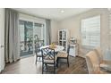 Bright dining area with modern table and chairs, sliding glass doors to a balcony and stylish decor at 3722 Ellington St, Charlotte, NC 28211