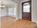 Elegant foyer featuring a decorative front door, hardwood floors, and natural light at 5164 Mill Race Ln, Lancaster, SC 29720