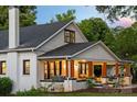 A beautiful white home with a covered porch and dark trim, perfect for relaxing and enjoying the outdoors at 606 1St W St, Conover, NC 28613