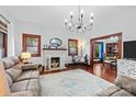 Inviting living room with a decorative fireplace, hardwood floors, and a vintage-style chandelier at 606 1St W St, Conover, NC 28613